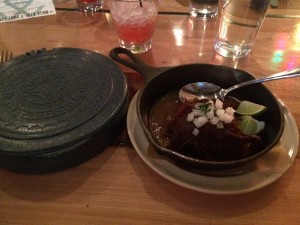 Roasted goat with ancho mole and handmade tortillas